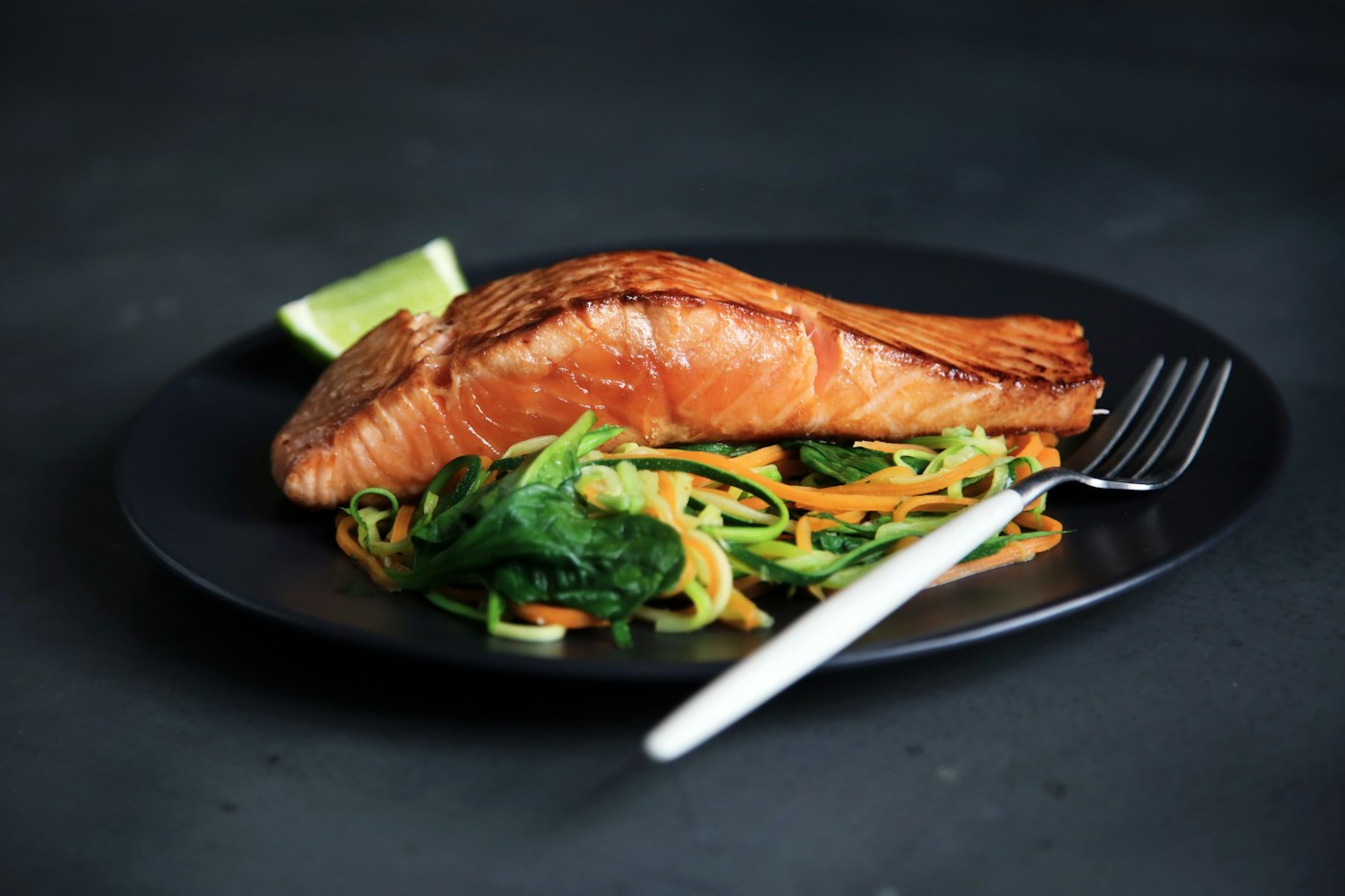 Gegrillter Fisch mit Gemüse auf dem Teller als Beispiel für antientzündliche Ernährung