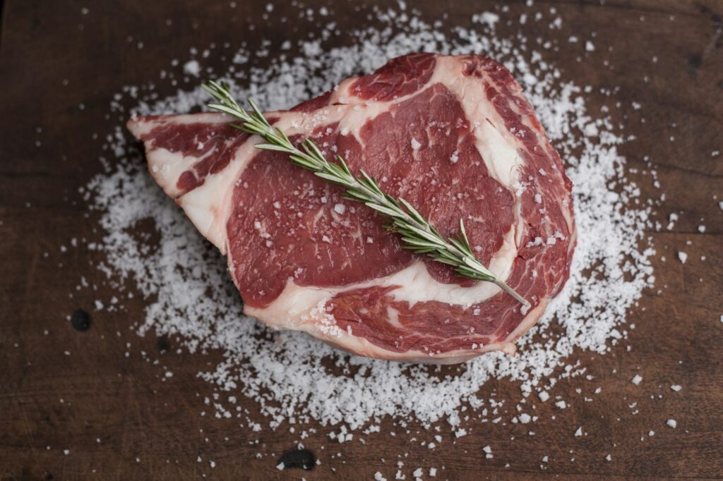 Rohes Fleisch auf Holztisch als Grundlage der Carnivore Diät