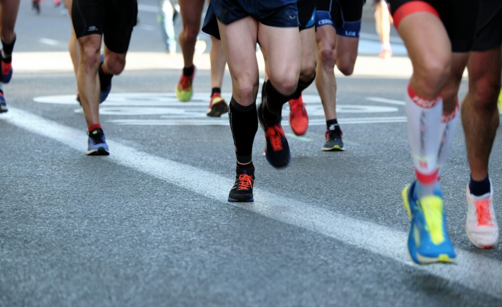 Menschen joggen gemeinsam auf einer Straße – Laufen für Anfänger in der Gruppe